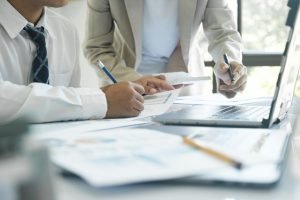 Reviewing and signing legal documents at a desk with a pen